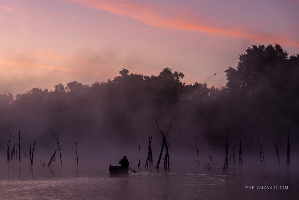 Misty pink dawn over a lake
